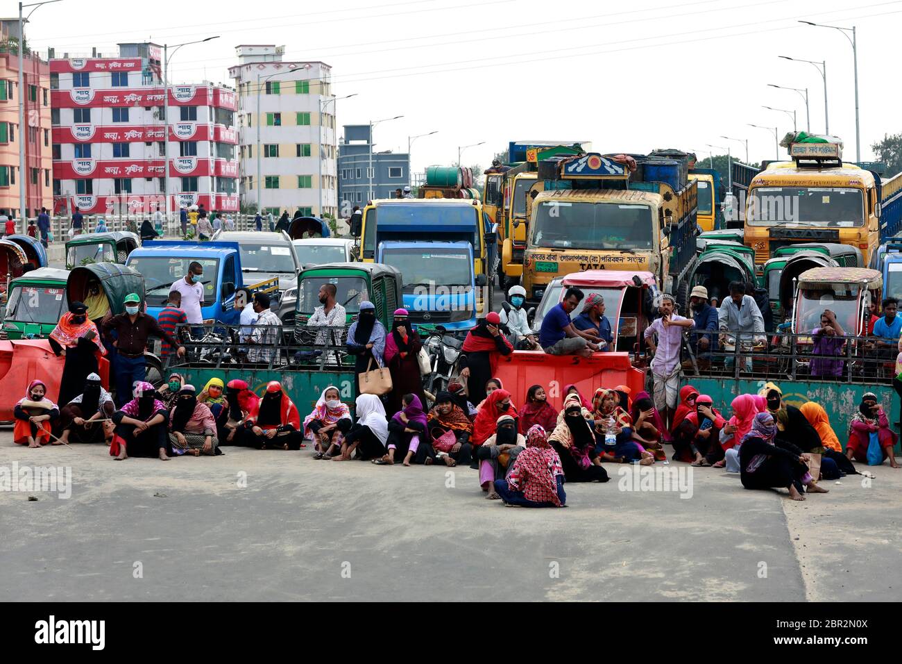 Dhaka, Bangladesh - 20 mai 2020 : les travailleurs du vêtement bangladais bloquent une route lorsqu'ils se rassemblent pour protester contre leurs salaires impayés dans tout le pays Banque D'Images