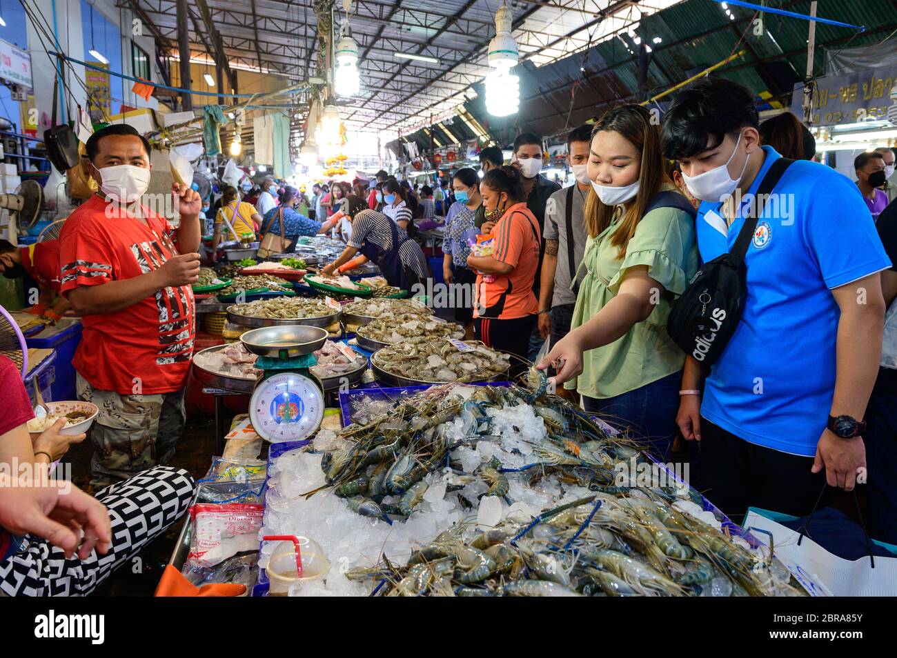 Les gens le masque de visage de matériel de choix de crevettes crues au marché de Pak Nam Banque D'Images