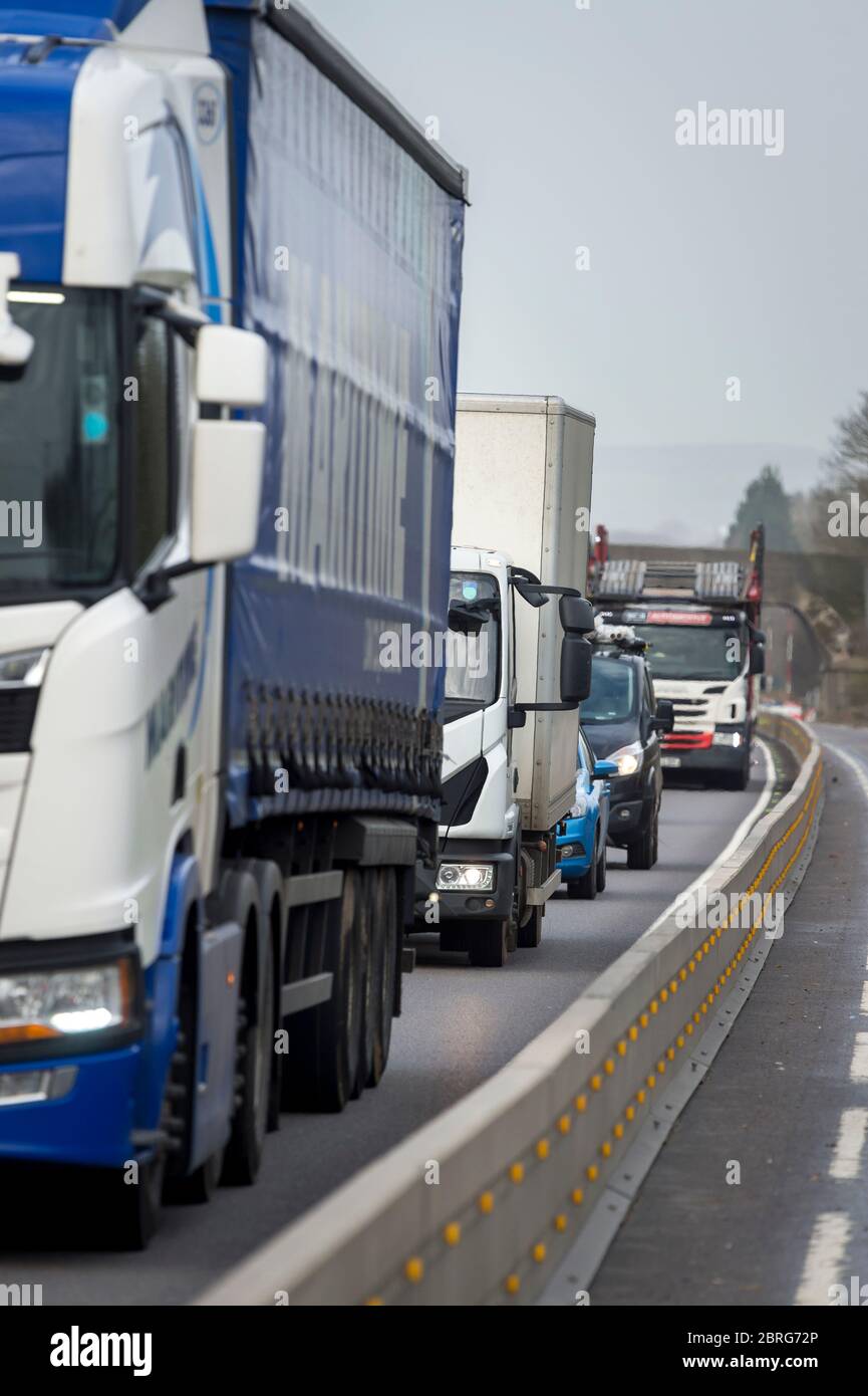 Circulation passant par des travaux routiers sur une autoroute très fréquentée en Angleterre, au Royaume-Uni. Banque D'Images