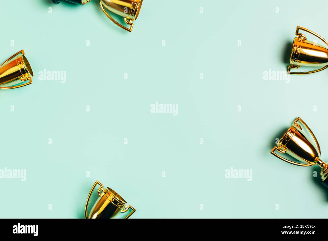 Cadre en tasses de vainqueur sur un fond bleu pastel avec espace de copie. Style plat. Banque D'Images