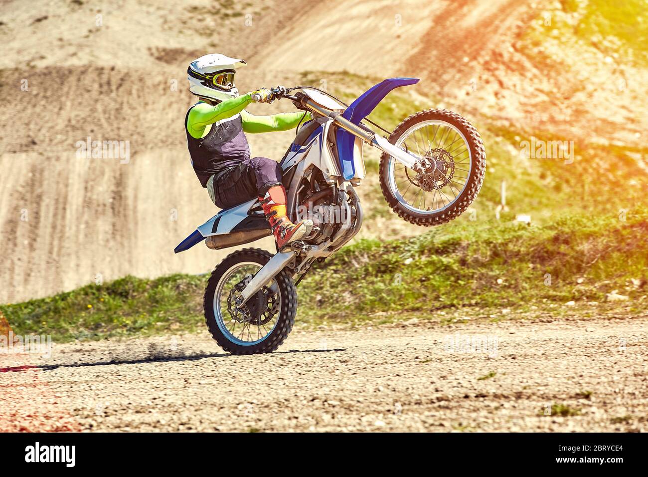 Motocross, un pilote se tient sur la roue arrière d'un vélo, la conduite  sur la roue arrière. Extrême, industriel, moto cross-country pour extrême  Photo Stock - Alamy