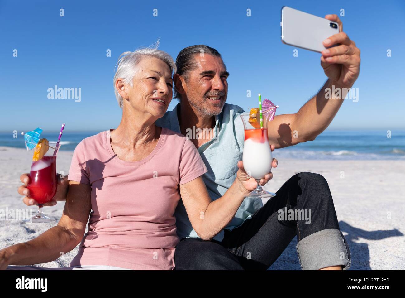 Couple caucasien senior prenant un selfie à la plage. Banque D'Images