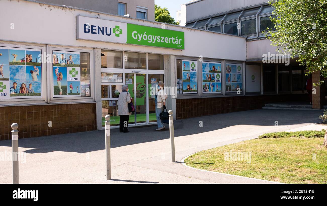 Gyor Hongrie 05 21 2020: Des clients âgés de sexe féminin attendent à l'entrée d'une pharmacie de Benu dans un masque protecteur en raison du coronavirus. Banque D'Images