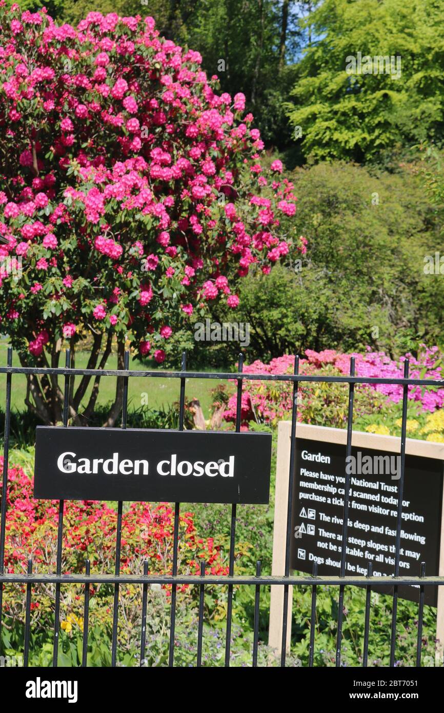 Jardin National Trust à Quarry Bank montrant le signe de fermeture du jardin contre les arbustes à fleurs brillantes pendant le coronavirus Banque D'Images