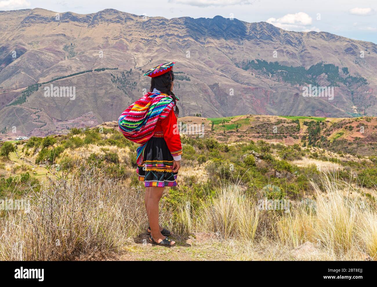 Femme autochtone quechua en vêtements traditionnels regardant la vallée sacrée de l'Inca près de Cusco, Pérou. Banque D'Images