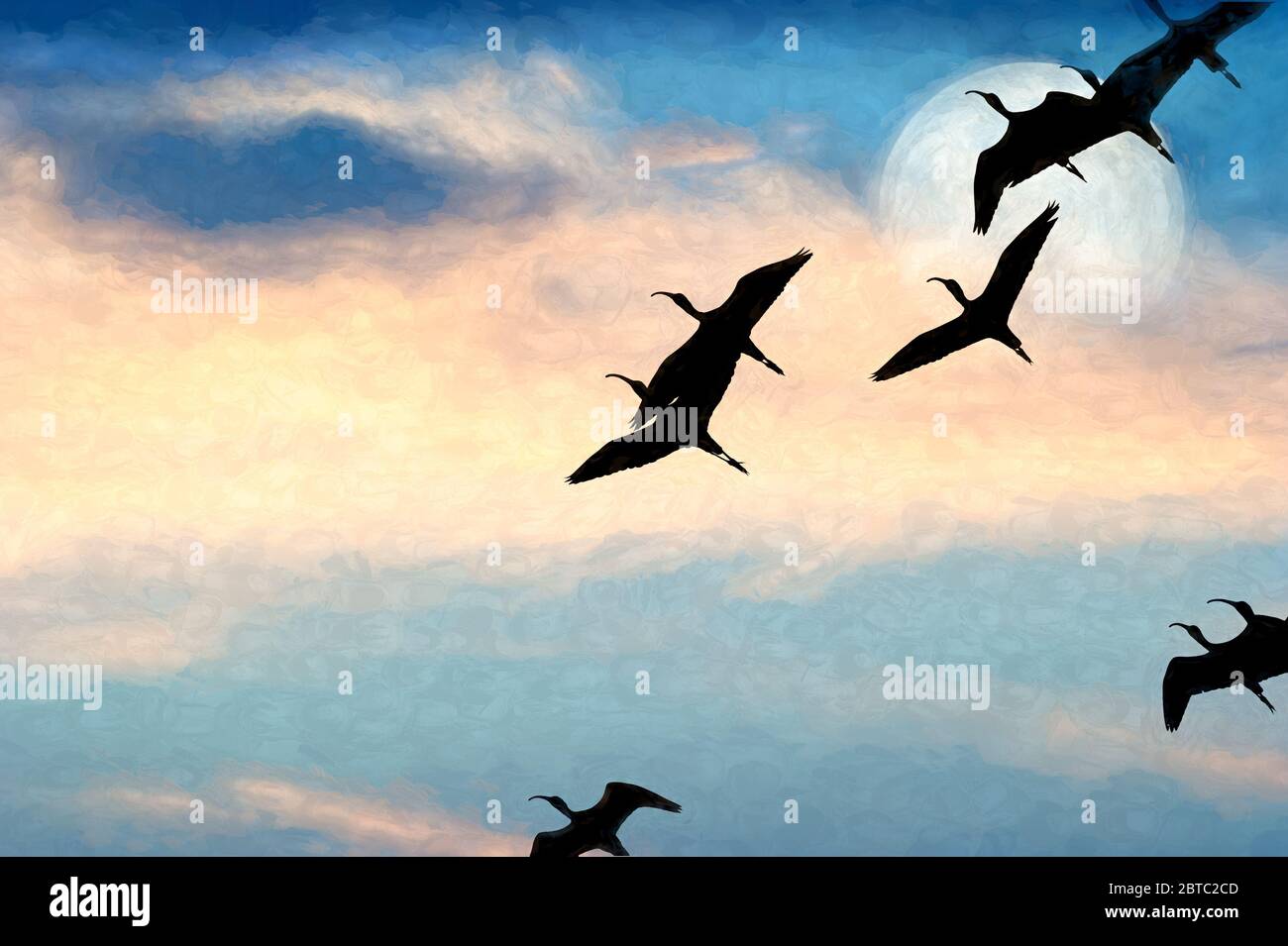 Une Flock of Birds silhouettée volant par la pleine Lune Banque D'Images