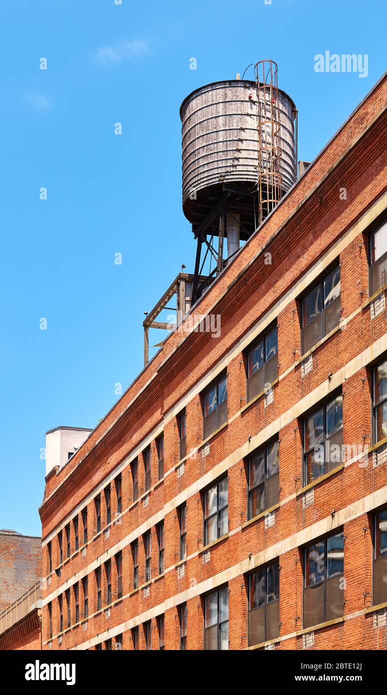 Réservoir d'eau sur le toit par temps ensoleillé, l'un des symboles de New York, USA. Banque D'Images