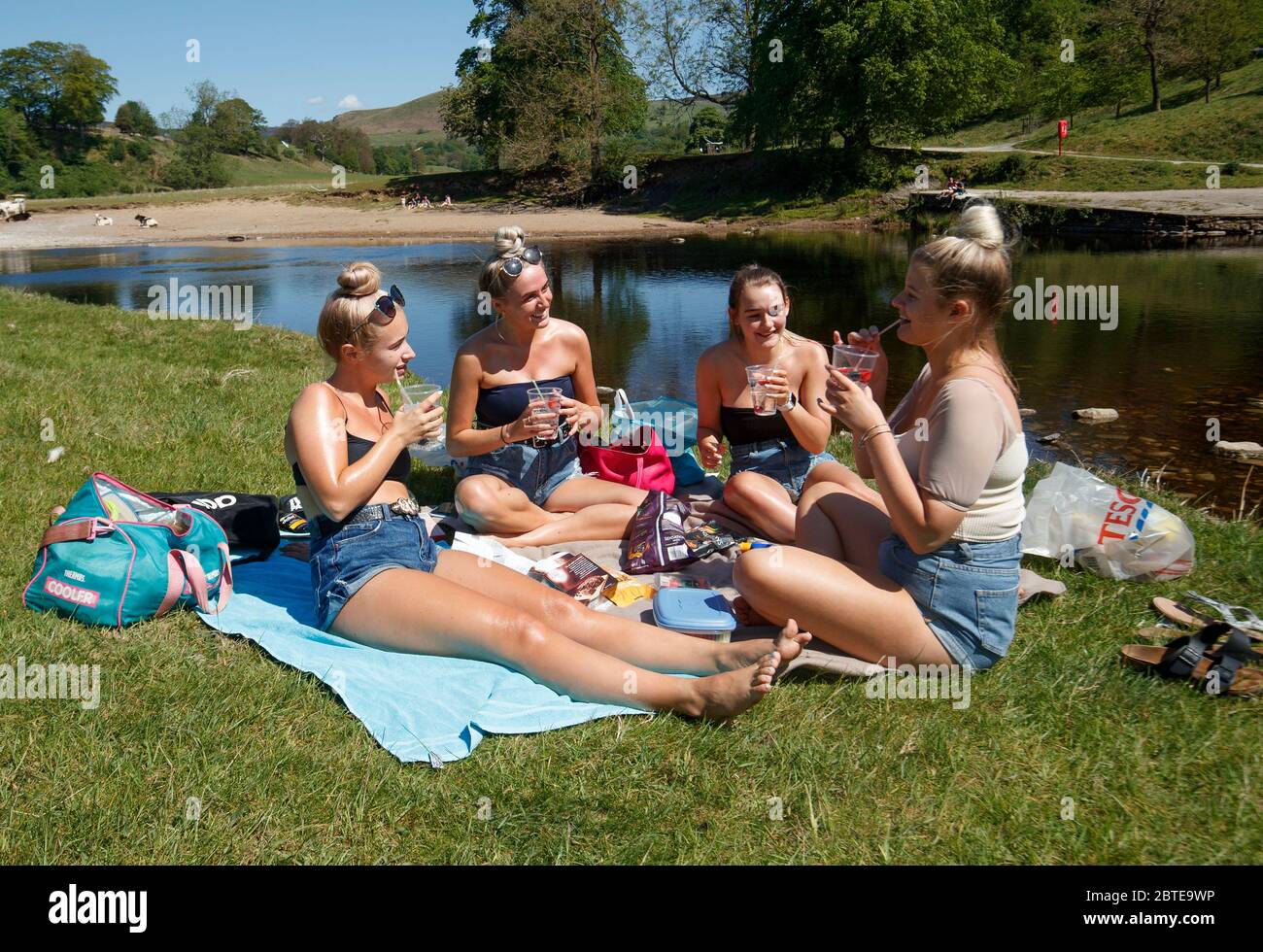 De gauche à droite, Kate Wormald, Lizzie Walker, Fiona Oddy et Millie Arnison apprécient le temps chaud à l'abbaye de Bolton dans le North Yorkshire, tandis que les gens affluent vers les parcs et les plages avec des mesures de confinement apaisées. Banque D'Images