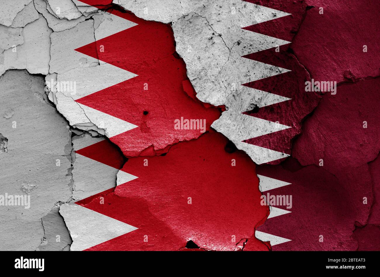 Drapeaux de Bahreïn et du Qatar peints sur un mur fissuré Banque D'Images