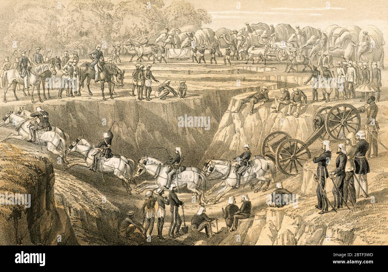 Artillerie Crossing a nullah. Le 53e Régiment coscoste un nullah ou nulla, un ruisseau ou un cours d'eau, sur leur chemin vers le soulagement de Lucknow pendant la rébellion indienne de 1857. D'après les souvenirs d'une campagne d'hiver en Inde, 1857-58, publié en 1869. Banque D'Images