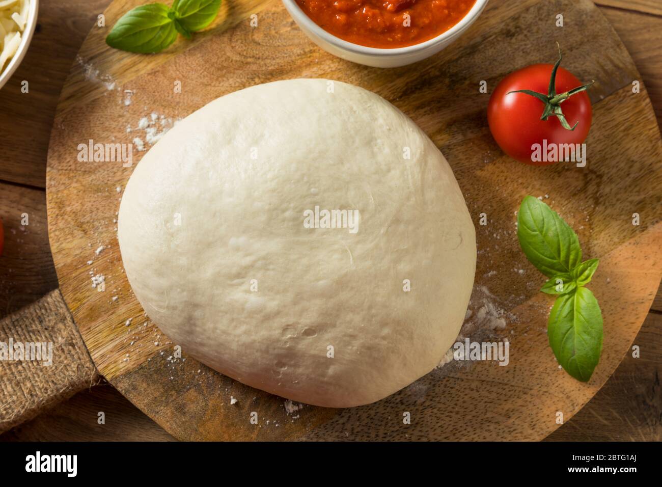 Pâte à pizza maison et ingrédients au basilic Banque D'Images