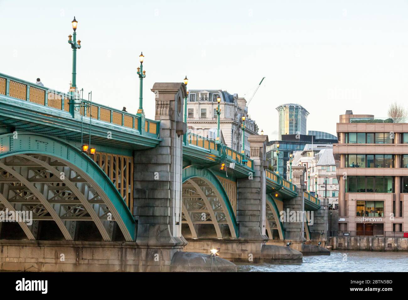 Southwark Bridge, avec ses lampadaires éclairés, vu de la rive sud, au-dessus de la Tamise à Londres Banque D'Images Southwark Bridge, avec ses lampadaires éclairés, vu de la rive sud, au-dessus de la Tamise à Londres Banque D'Images
