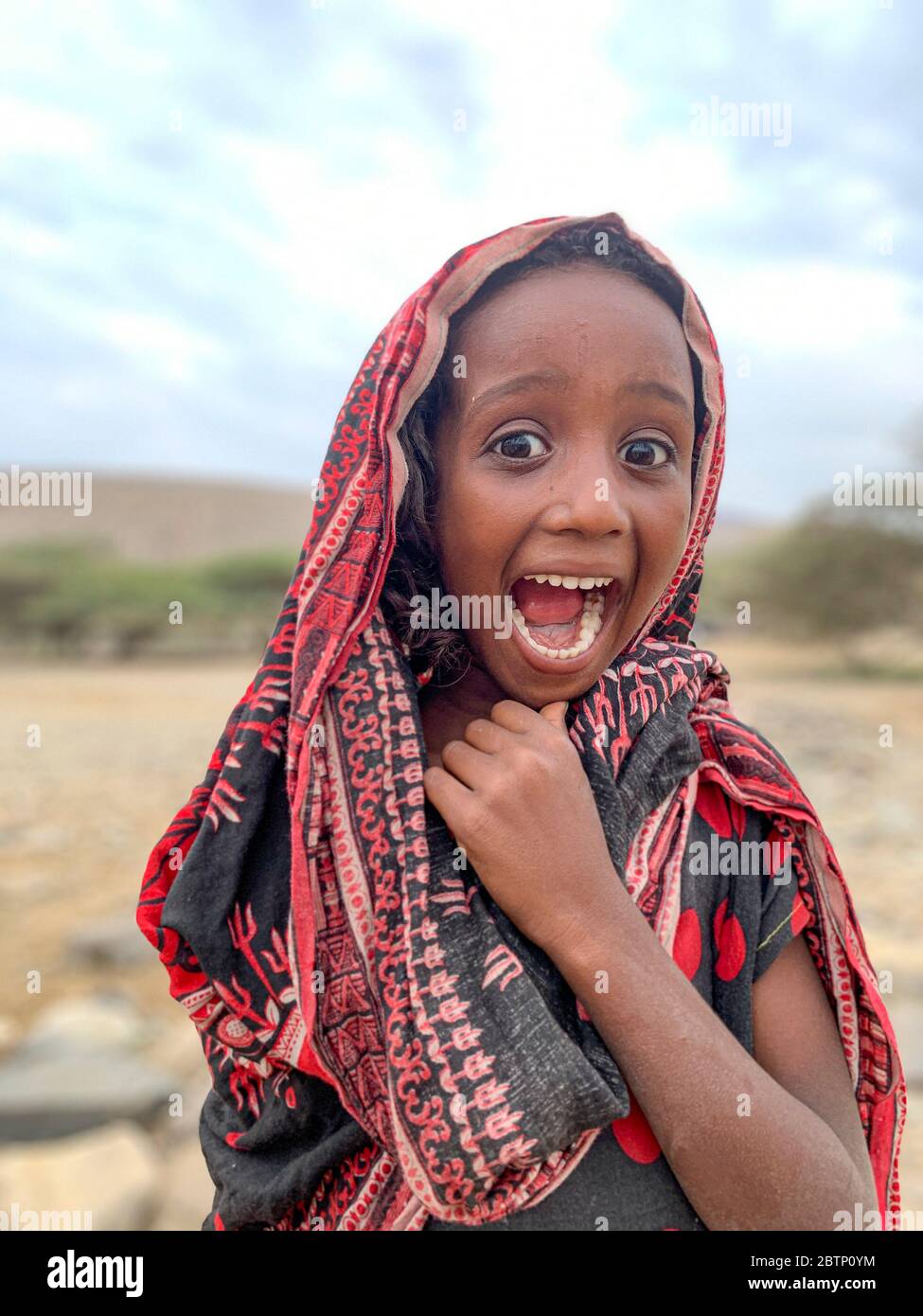 Bonne fille de bébé avec hijab musulman tête enveloppante rire, Danakil Dépression, région d'Afar, Éthiopie, Afrique Banque D'Images