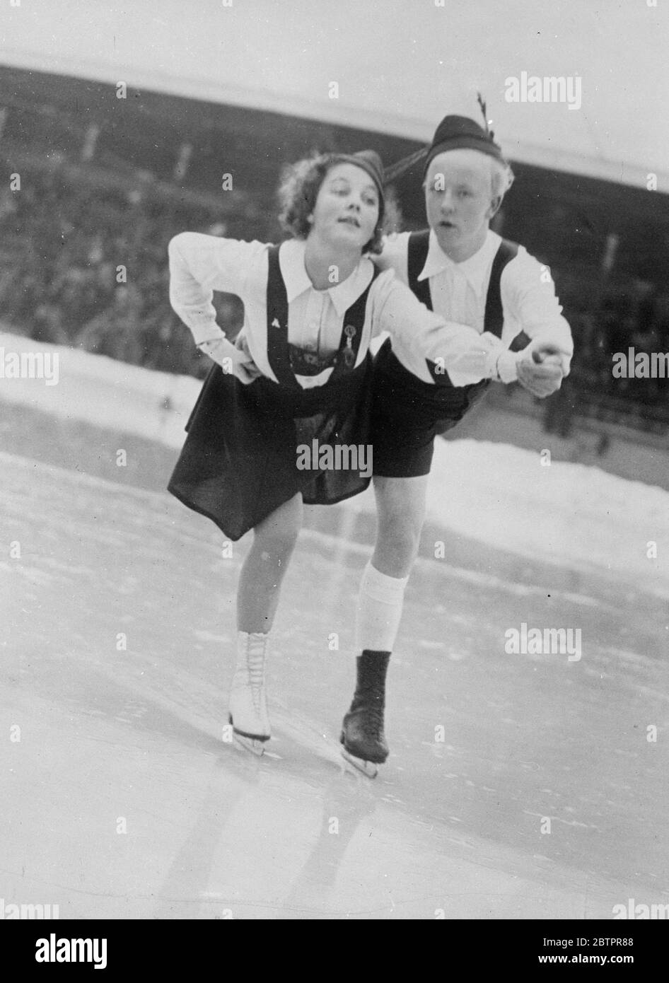 Danse tyrolienne sur la glace. Gunnel Ericsson (à gauche) et Bo Mothander, fille et garçon les plus prometteurs de Suède, patineurs, effectuant une danse atyrolienne sur la glace au stade de Stockholm, où ils s'entrainement dur pour les championnats du monde. Ils détiennent déjà le championnat de patinage en couple suédois. 27 janvier 1938 Banque D'Images