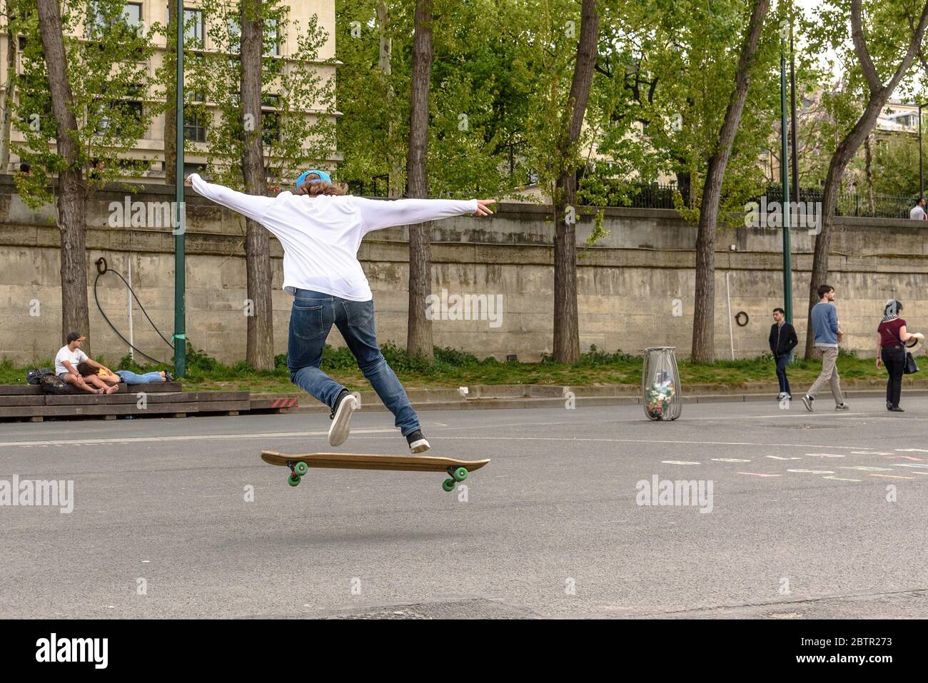 Un skateboarder exécutant un ollie sur le remblai de Quai Anatole France Banque D'Images