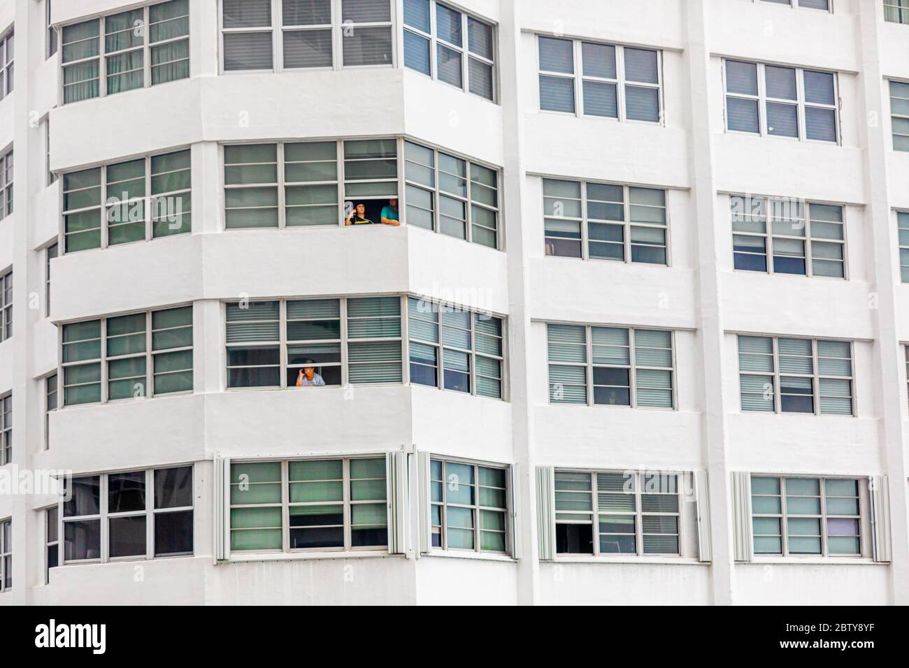 Les personnes sans balcon sont confrontées au confinement de la pandémie par leurs fenêtres dans l'immeuble four Ambassadors Apartment Building, Miami, Floride, United Stat Banque D'Images