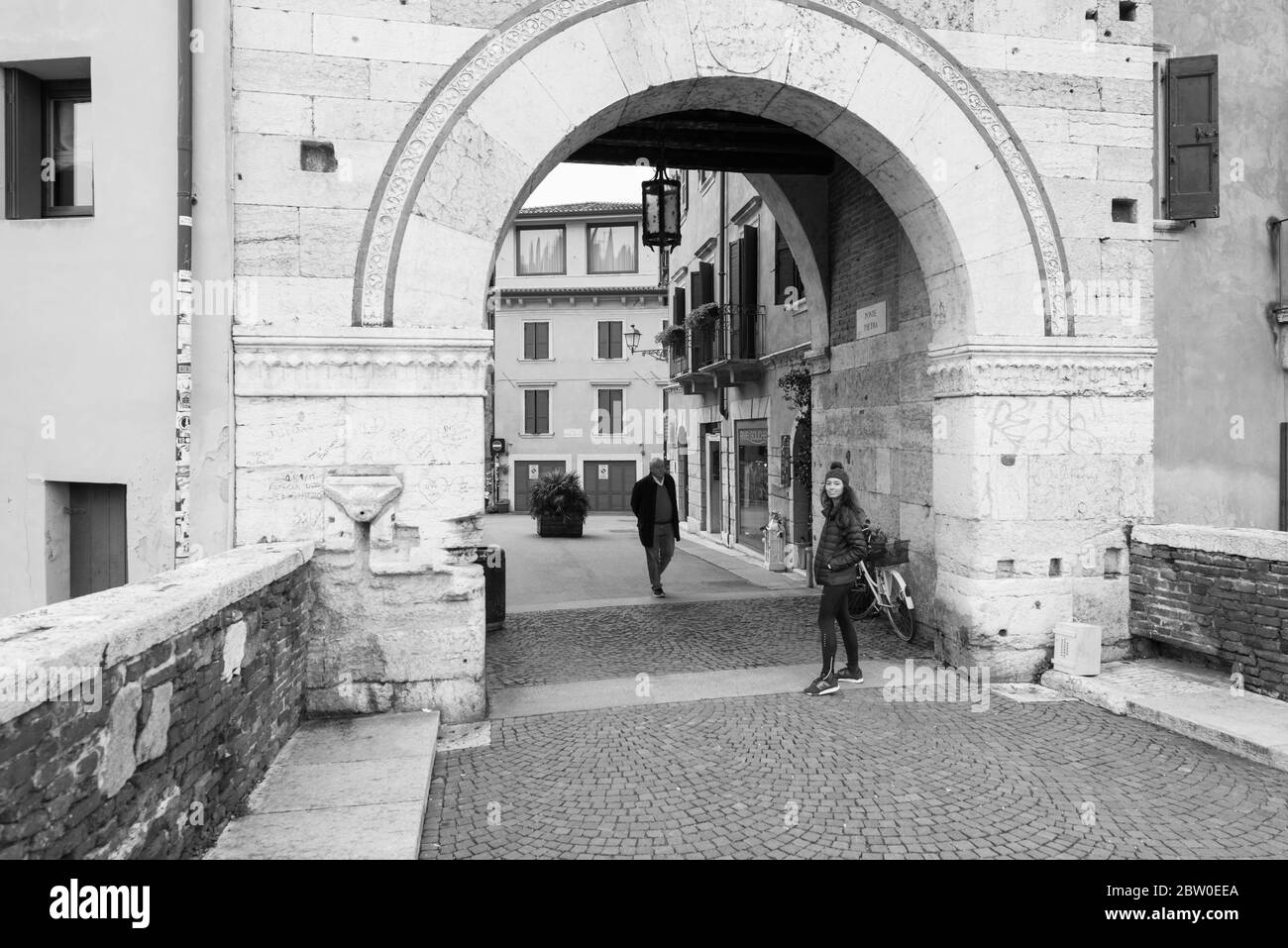 VÉRONE, ITALIE - 14, MARS 2018 : photo en noir et blanc des gens de Ponte Pietra, un célèbre pont de Vérone, Italie Banque D'Images