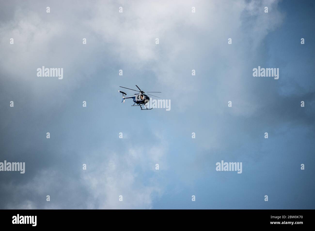 Un hélicoptère unique avec un fond sombre et nuageux Banque D'Images