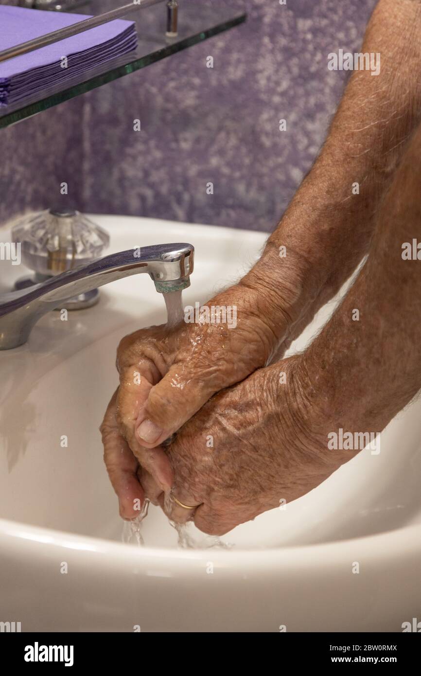 Les mains sous le robinet d'eau courante Banque D'Images