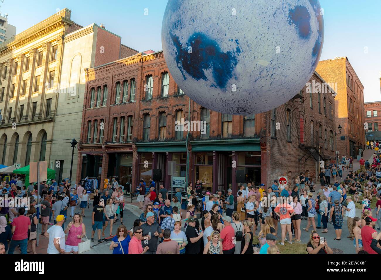 Saint John, NB, Canada - le 20 juillet 2019 : une lune gonflable au-dessus d'une foule de gens au Moonlight Bazaar annuel. L'événement attire des milliers de visi Banque D'Images