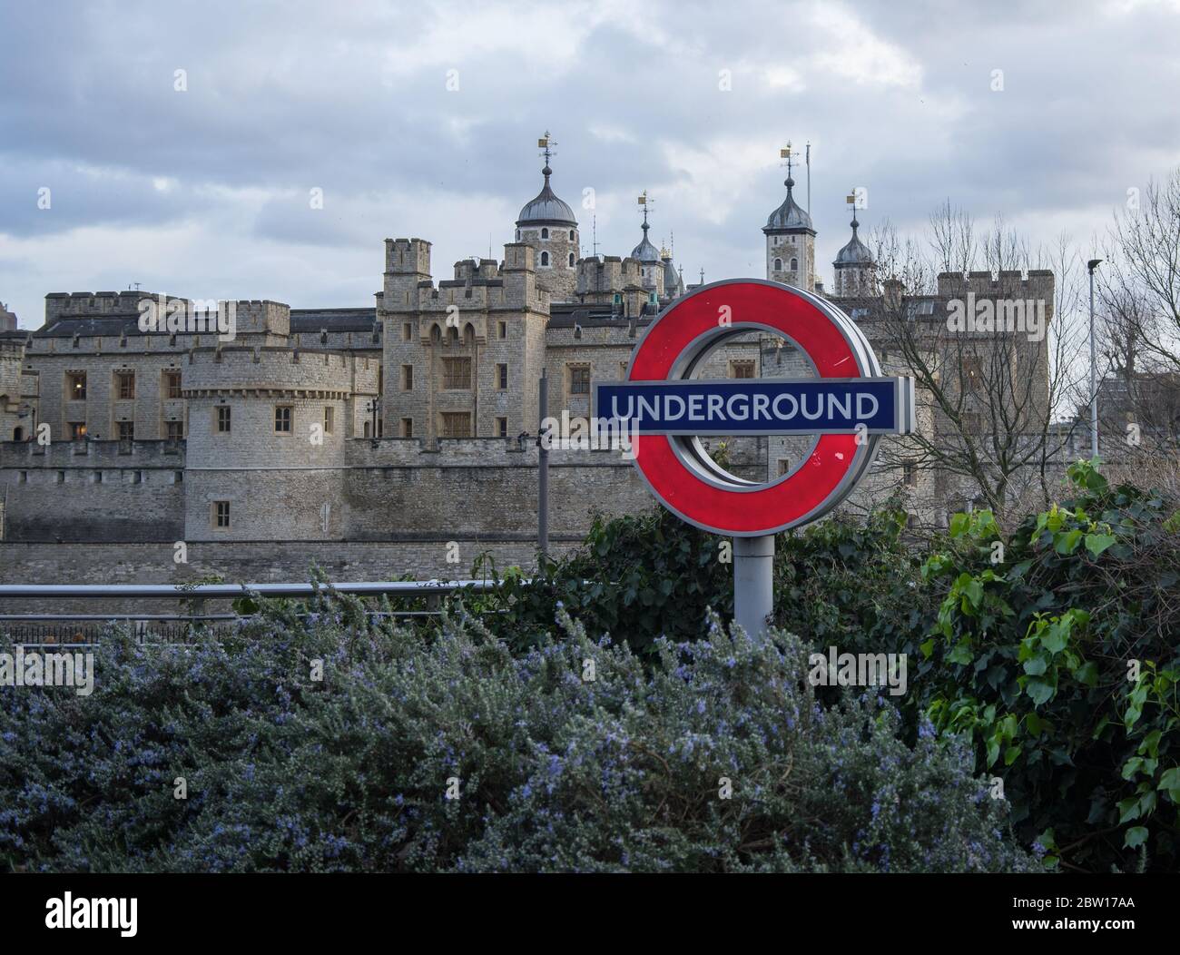 Panneau rond du métro de Londres avec la Tour de Londres en arrière-plan. Banque D'Images