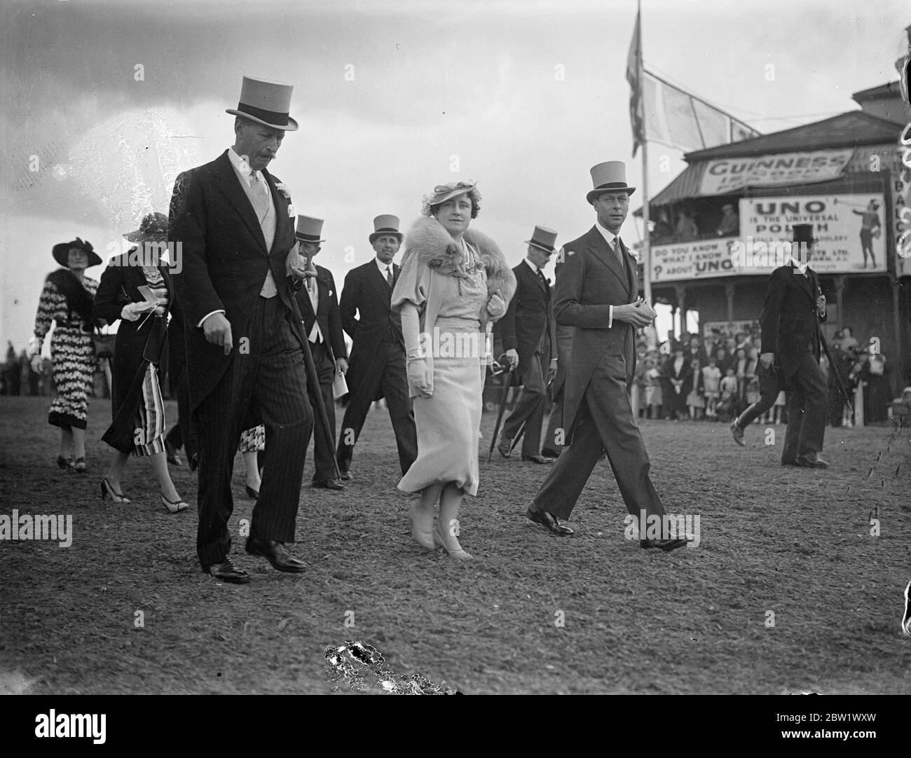 King et Queen marchaient jusqu'au paddock à Epsom le jour de Oaks. Le Roi et la Reine, en payant une deuxième visite en trois jours, ils peuvent marcher sur le parcours d'Epsom jusqu'au paddock avant le début des Oaks. Spectacles photo, le roi et la reine marchant jusqu'au paddock à Epsom. 4 juin 1937 Banque D'Images