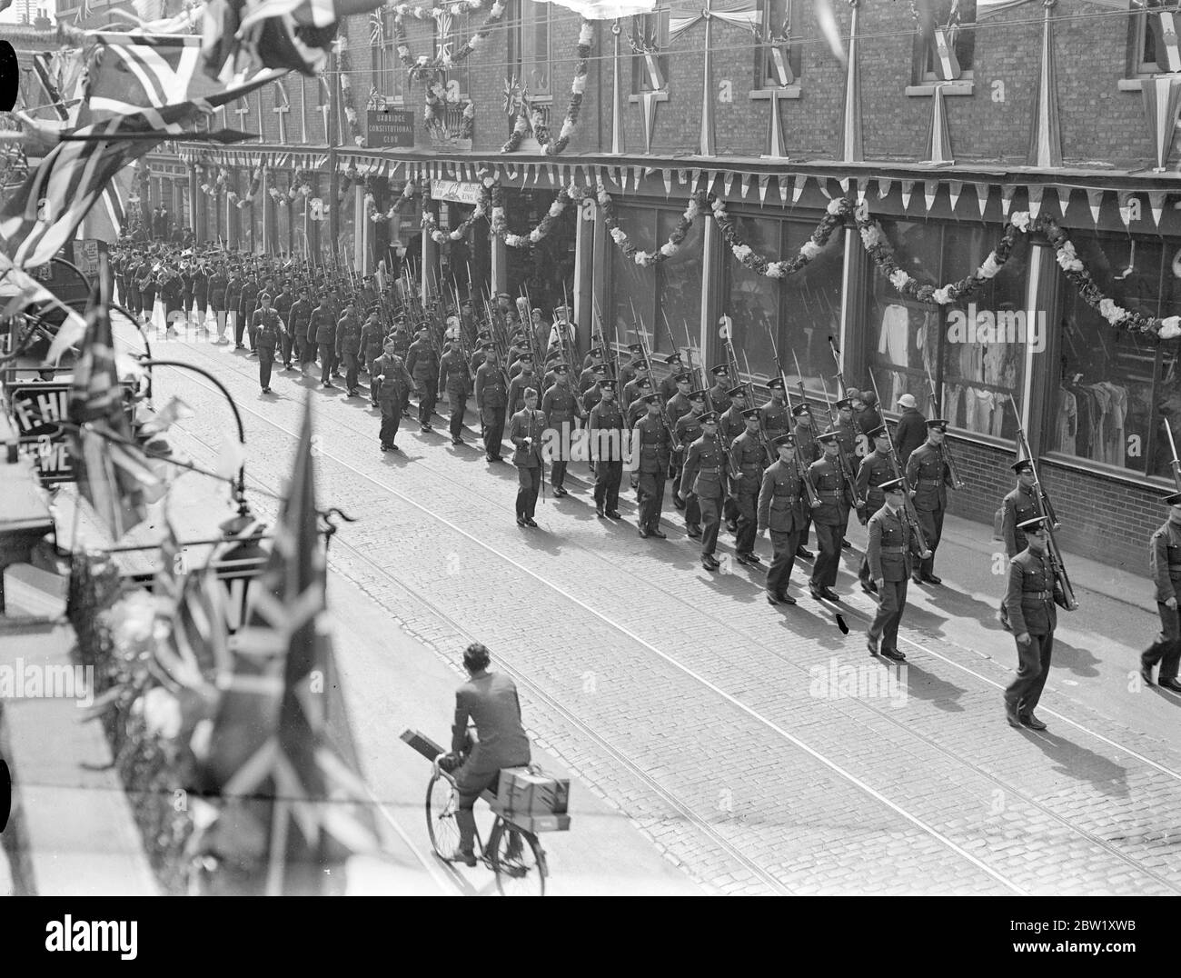 Les hommes de la RAF ont l'habitude de regarder les foules pour le Coronation. Le personnel de la Royal Air Force a répété à Uxbridge pour les tâches de la Journée du Couronnement. Dirigés par leur groupe, ils ont défilé sur Uxbridge High Street pour les habituer à la foule. Des expositions de photos, les hommes de la RAF défilant dans Uxbridge High Street. 6 mai 1937 Banque D'Images