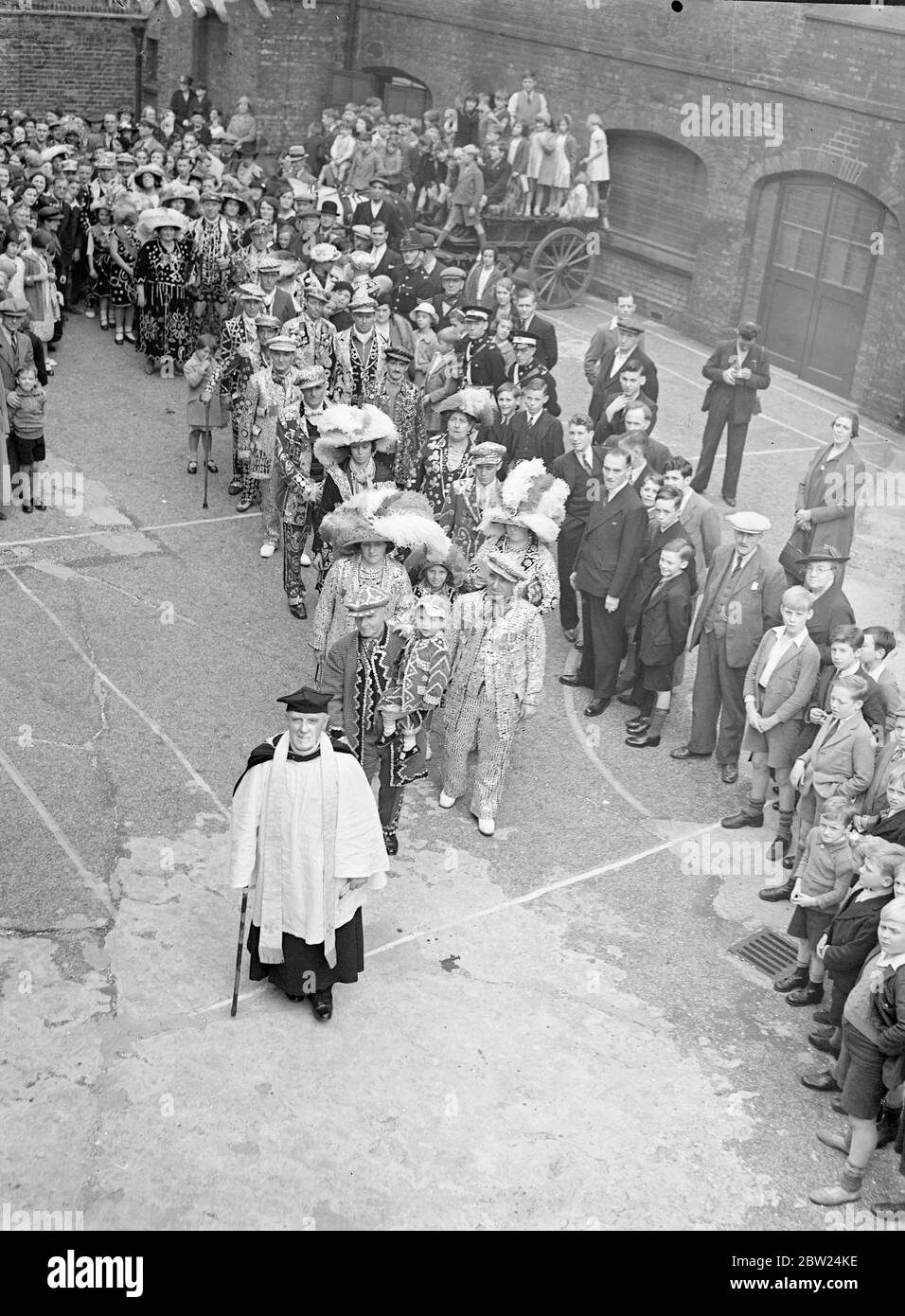 Après 15 ans de travail dans le quartier, l'évêque Coster, le révérend CJ Barker, a dirigé son dernier service pour le costermonger de Londres à l'église St Mary's Church, dans la rue Old Kent Road, dans le sud de Londres. Il prend sa retraite pour des raisons de santé. Le révérend Barker est entré entièrement dans la vie de son paroissieur, même en visitant toutes les maisons publiques de la paroisse, pendant ses premiers jours dans le district. Photos: Le révérend CJ Narker dirigeant la procession des rois et des reines dans l'église pour la dernière fois aujourd'hui. 11 septembre 1938 Banque D'Images Après 15 ans de travail dans le quartier, l'évêque Coster, le révérend CJ Barker, a dirigé son dernier service pour le costermonger de Londres à l'église St Mary's Church, dans la rue Old Kent Road, dans le sud de Londres. Il prend sa retraite pour des raisons de santé. Le révérend Barker est entré entièrement dans la vie de son paroissieur, même en visitant toutes les maisons publiques de la paroisse, pendant ses premiers jours dans le district. Photos: Le révérend CJ Narker dirigeant la procession des rois et des reines dans l'église pour la dernière fois aujourd'hui. 11 septembre 1938 Banque D'Images