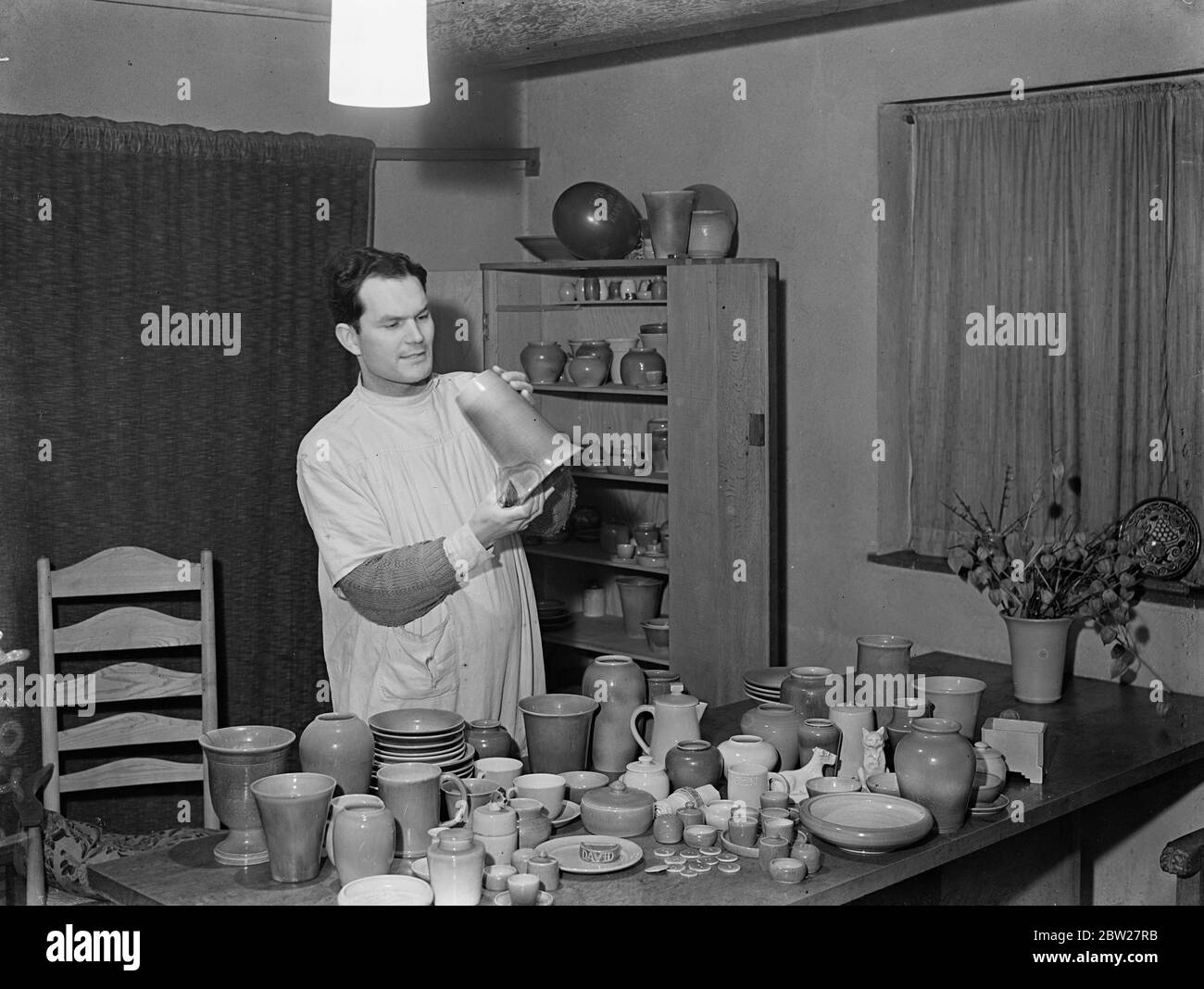 Londres a encore un potter. M. Ronald Czilinsky, l'un des derniers potiers professionnels du quartier de Londres, a travaillé dans une maison qu'il a construite pour lui-même et sa famille à Harrow Weald, Middlesex. M. Czilinsky, concepteur et potier, a fait ses propres fours, potiers et meubles de maison. Il a converti sa salle à manger en studio. Malgré la production de masse, M. Czilinsky affirme qu'il existe encore un marché limité pour la poterie à main, et il soutient qu'il a un style et une finition que d'autres méthodes ne peuvent pas donner. Il est d'avis que les hommes font de meilleurs potiers que les femmes. Pour Banque D'Images