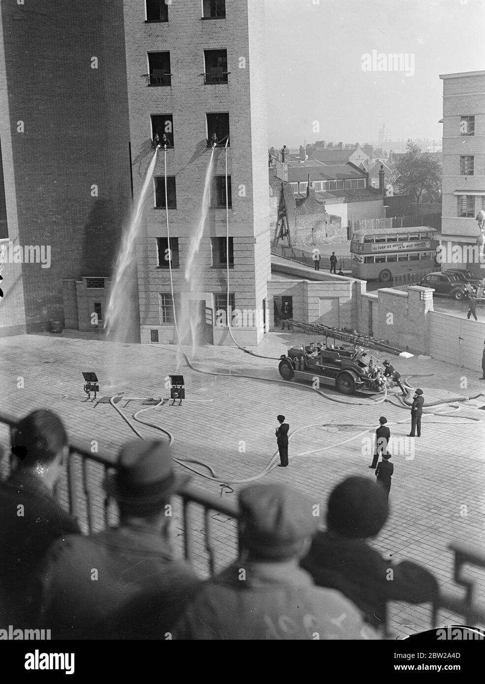 Finale de la compétition de pompe de la Brigade des pompiers de Londres. La finale de la compétition de pompe de la Brigade des pompiers de Londres a eu lieu pour la première fois au nouveau quartier général sur le remblai Albert. Six équipes ont participé. L'équipe gagnante était le no 40 nouvelles expositions de photos croisées B, l'ancienne équipe no 82 de Kent Road B dirigeant les tuyaux sur les cibles au sol depuis la tour d'entraînement. 26 octobre 1937. Banque D'Images