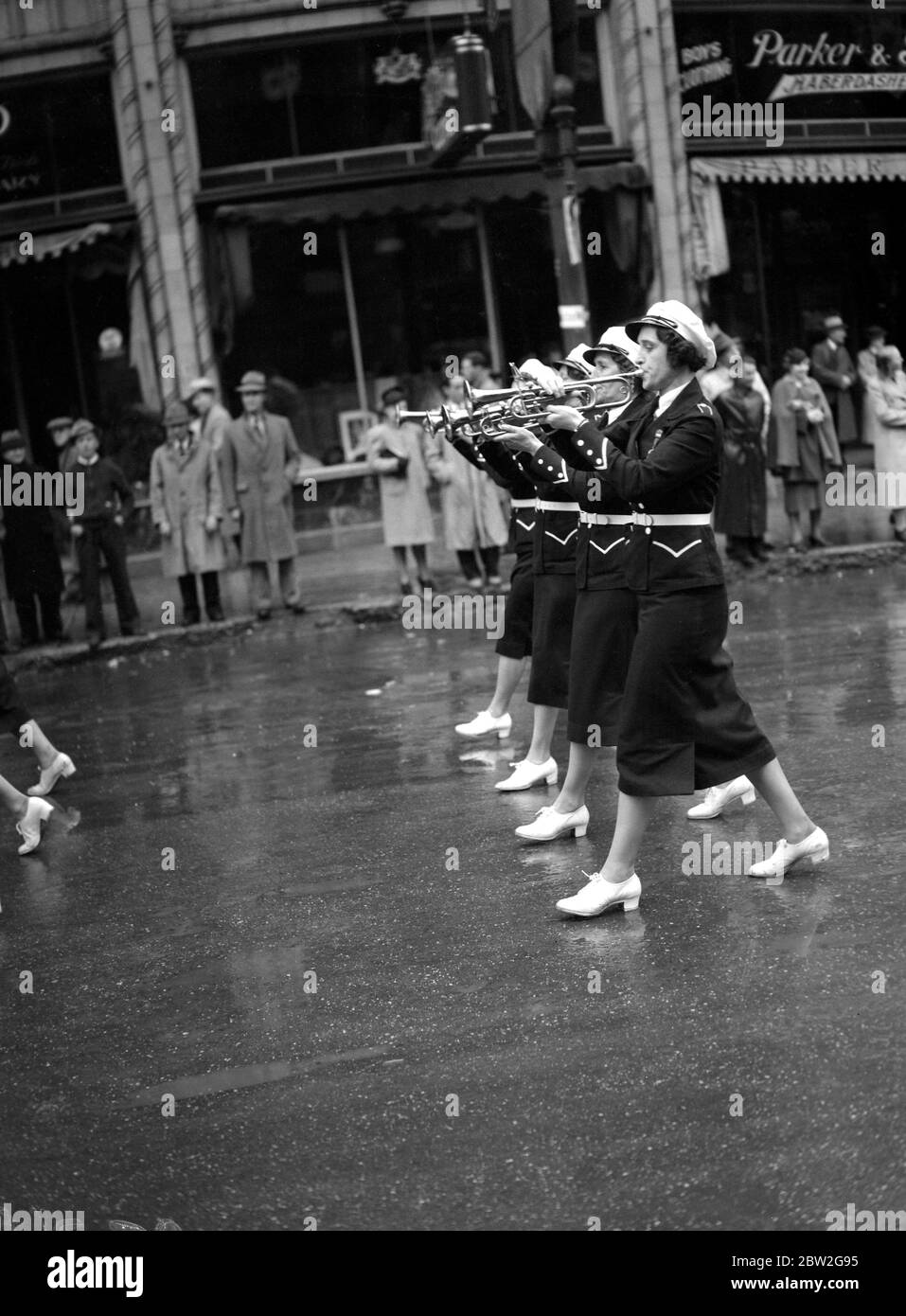 La tournée royale du Canada et des États-Unis par le roi George VI et la reine Elizabeth , 1939 le roi et la reine étant accueillis par la Thief River Falls Girl Band du Minnesota , États-Unis , en paradant sous la pluie sur Portage Avenue , la rue principale de Winnipeg , Canada Banque D'Images
