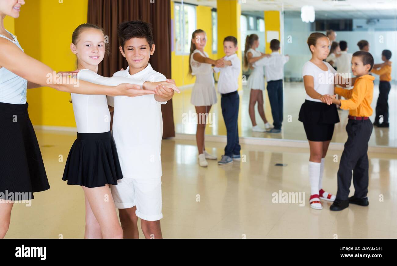 Des enfants souriants et actifs dansent en classe Banque D'Images