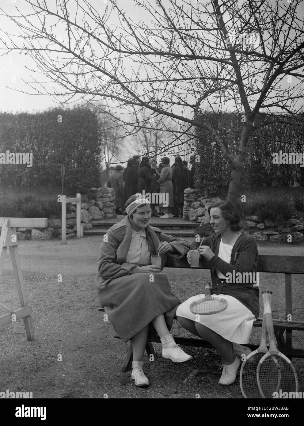 Rafraîchissements après un duel au tournoi de tennis de Roehampton . Mme Wheatcroft ( à droite ) et Mlle Joan Ridley prenant des rafraîchissements lors d'une trêve aux championnats de tennis de Surrey Hard courts au Roehampton Club , Londres . 6 avril 1932 Banque D'Images