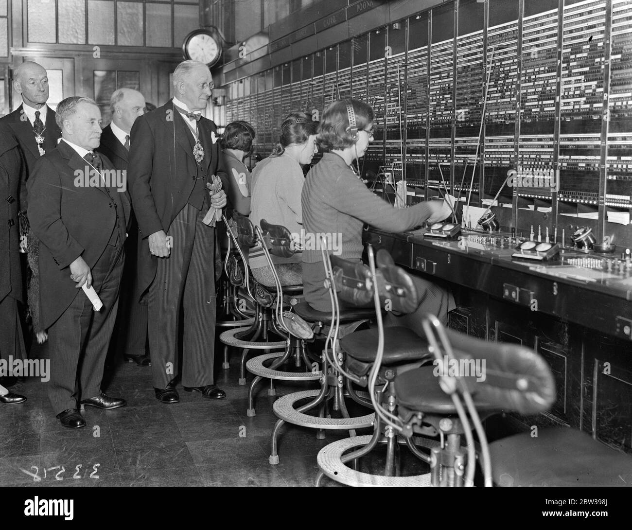 Lord Mayor inspecte un service téléphonique international . Le Lord Mayor de Londres ( Sir Charles H Collett ) a effectué une visite officielle à la Bourse téléphonique internationale du Faraday Building , Queen Victoria Street , Londres . Photos ; le Lord Mayor inspectant l'échange comme les opérateurs de filles parlaient à New York sur le téléphone transatlantique . 18 avril 1934 . 30s, 30s, 1930, 1930, 1930, trente, dix-neuf trente Banque D'Images