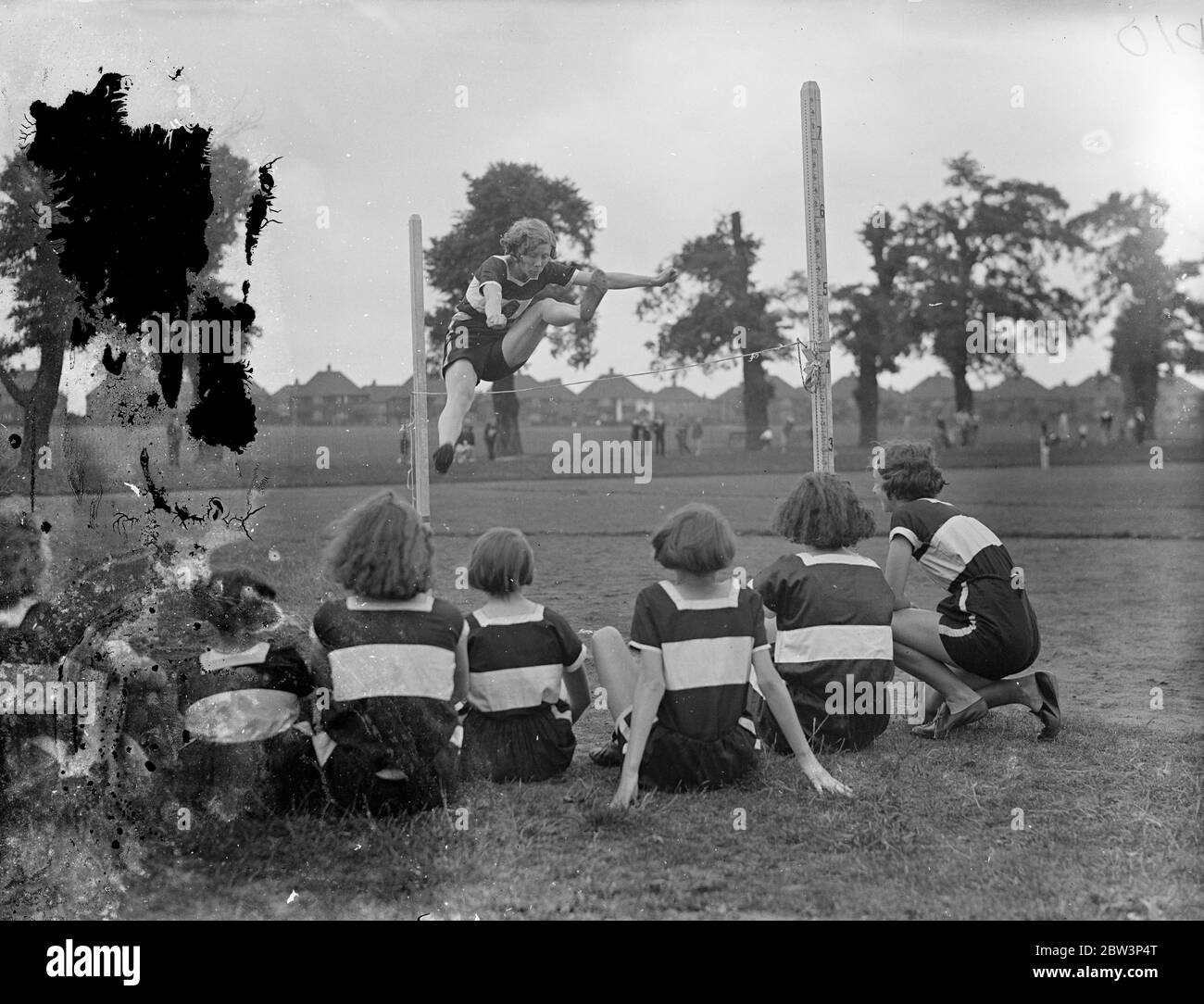 Les femmes athlètes s'entraînent à Charlton pour la réunion de White City . Les athlètes féminins des clubs de tout le pays s'entraînent sur la piste de Charlton Park pour la rencontre de l'Association sportive amateur des femmes à White City le 18 juillet. Photos : Mlle Morton , de Cambridge Harriers , regardée par d'autres membres , pratiquant pour le saut à Charlton . 5 juillet 1936 Banque D'Images