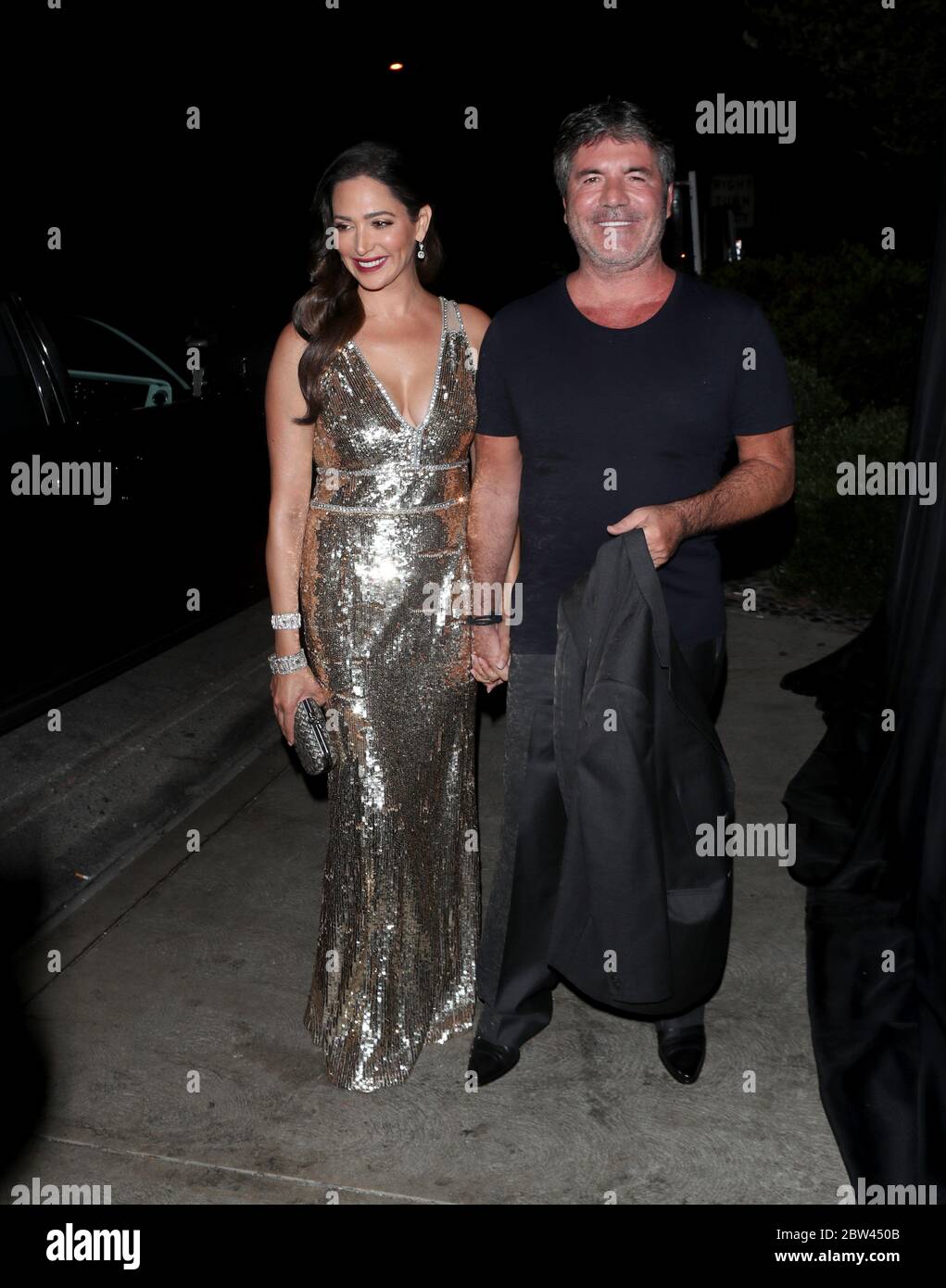 Simon Cowell et sa petite amie Lauren Silverman à LOS ANGELES lors d'une fête pour célébrer sa star hollywoodienne sur la promenade de la renommée, le 2018 août Banque D'Images