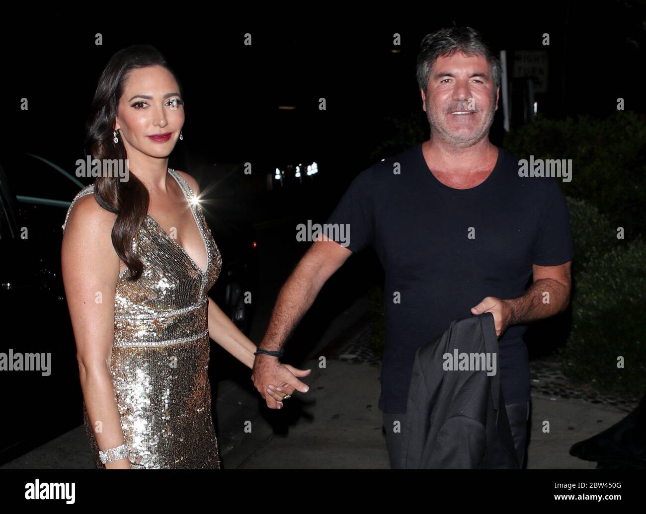 Simon Cowell et sa petite amie Lauren Silverman à LOS ANGELES lors d'une fête pour célébrer sa star hollywoodienne sur la promenade de la renommée, le 2018 août Banque D'Images