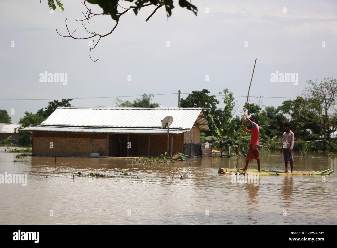 Nagaon, Inde. 29 mai 2020. Deux garçons voient un radeau à bananes pour atteindre les terres hautes comme leur maison est submergée dans les eaux d'inondation au village de Tetelisara près de Kampur ville dans Nagaon district d'Assam, Inde (photo par Simanta Talukdar/Pacific Press) Credit: Pacific Press Agency/Alay Live News Banque D'Images