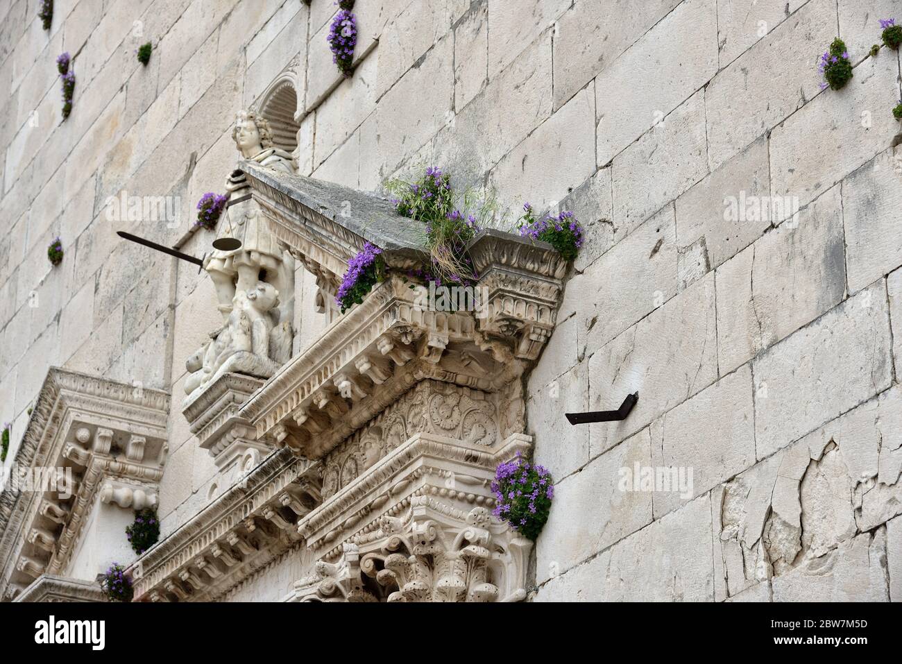Les fleurs poussent de manière luxuriante sur les murs de l'église principale de la vieille ville d'Omis, Dalmatie, Croatie Banque D'Images