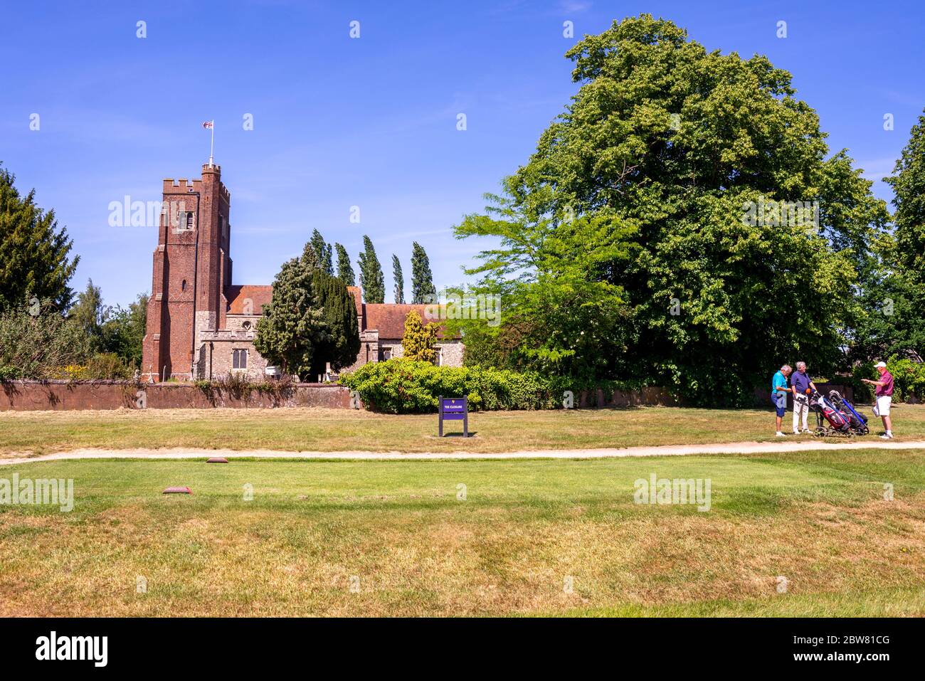 Église Saint Andrews, dans le parcours de golf du club de golf de Rochford Hundred. La tour Tudor et la C16 North Vestry. Trois golfeurs discutant du jeu Banque D'Images