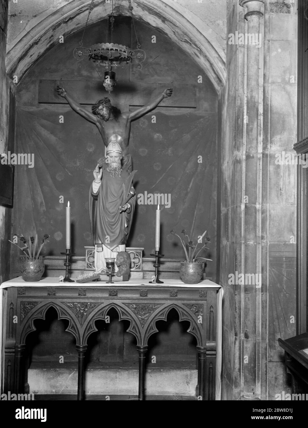 Bénédiction de la gorge , cérémonie vieille de plusieurs siècles au coeur de Londres . La statue de St Blaise à l'ancien catholique romain de St Etheldreda , Holborn , où une paire de longues bougies sera dédiée au Saint , et après avoir été illuminé touchera les gorges de ceux qui prennent part à la Bénédiction . 2 février 1927 Banque D'Images