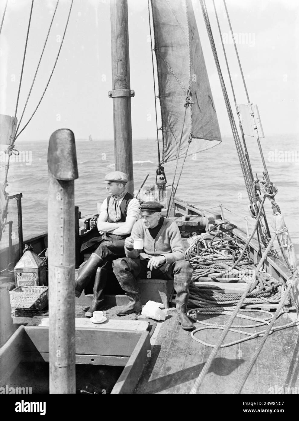 Les crevettes font une pause sur leur bateau avec les filets moulus . 1936 Banque D'Images