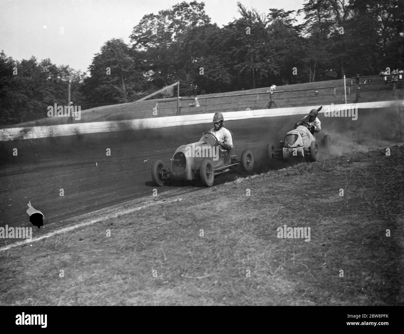 Le Grand prix de la course de voitures miniatures Crystal Palace . Les voitures prennent le virage . 1938 Banque D'Images