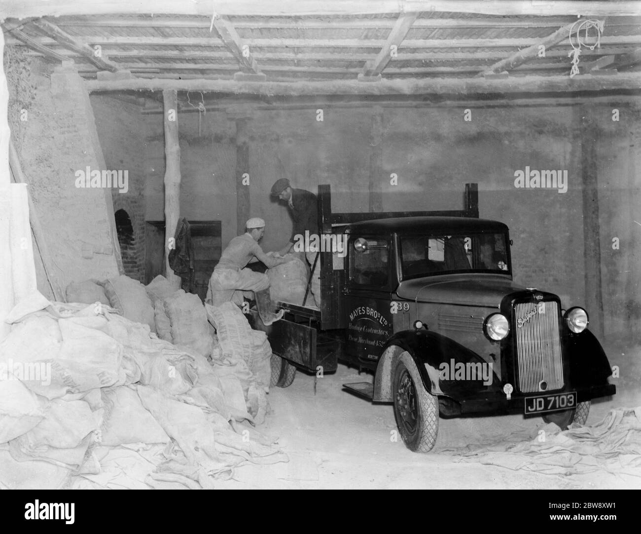 Un camion Bedford appartenant à la Mayes Bros Haulage Ltd , les entrepreneurs en transport , sacs de déchargement . 1938 . Banque D'Images
