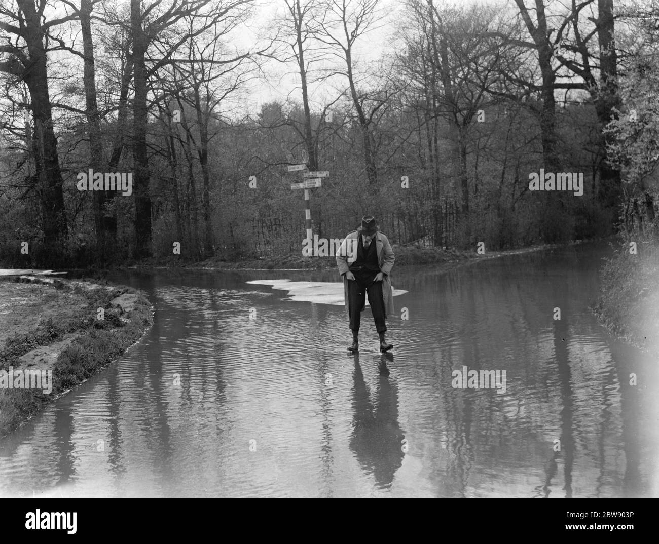 Un homme marche à travers les inondations à Hockenden , dans le Kent . 1937 Banque D'Images