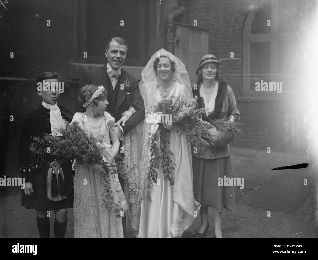 Evelyn Laye une demoiselle d'honneur au mariage de Soho . Madame Evelyn Laye l'actrice était la chef de six demoiselles d'honneur lors du mariage de Mlle Heather Macleod à M. Vincent Ash qui a eu lieu à l'église St Annes , Soho , Londres . La mariée et le marié avec Mlle Evelyn Laye après la cérémonie . 6 février 1932 . Banque D'Images