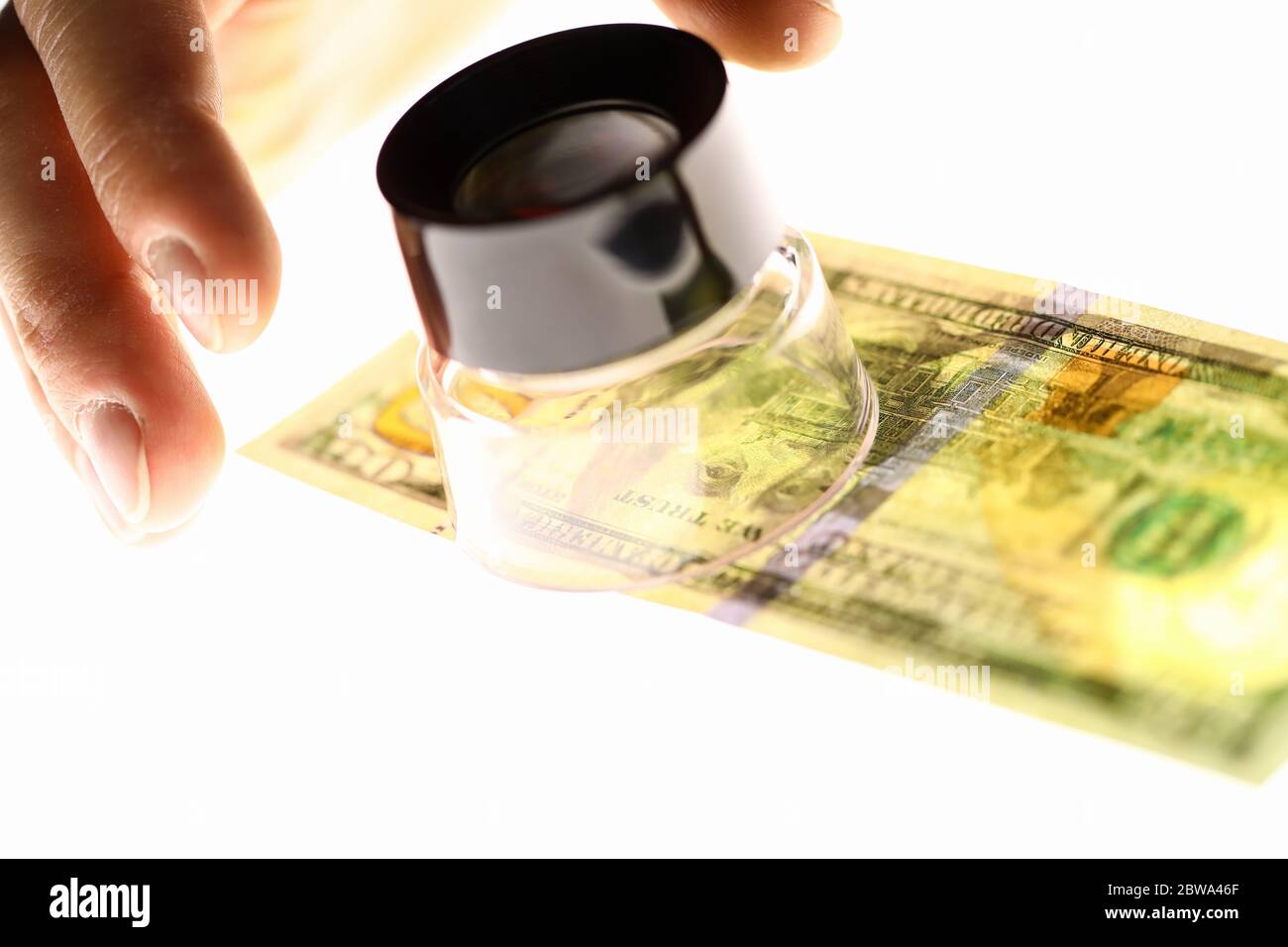 Main avec loupe et dollars, chèque d'argent Banque D'Images