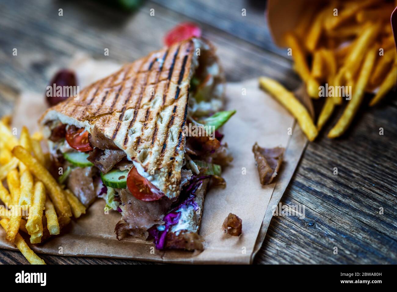Faire don de kebab avec des légumes et des frites sur une table en bois Banque D'Images