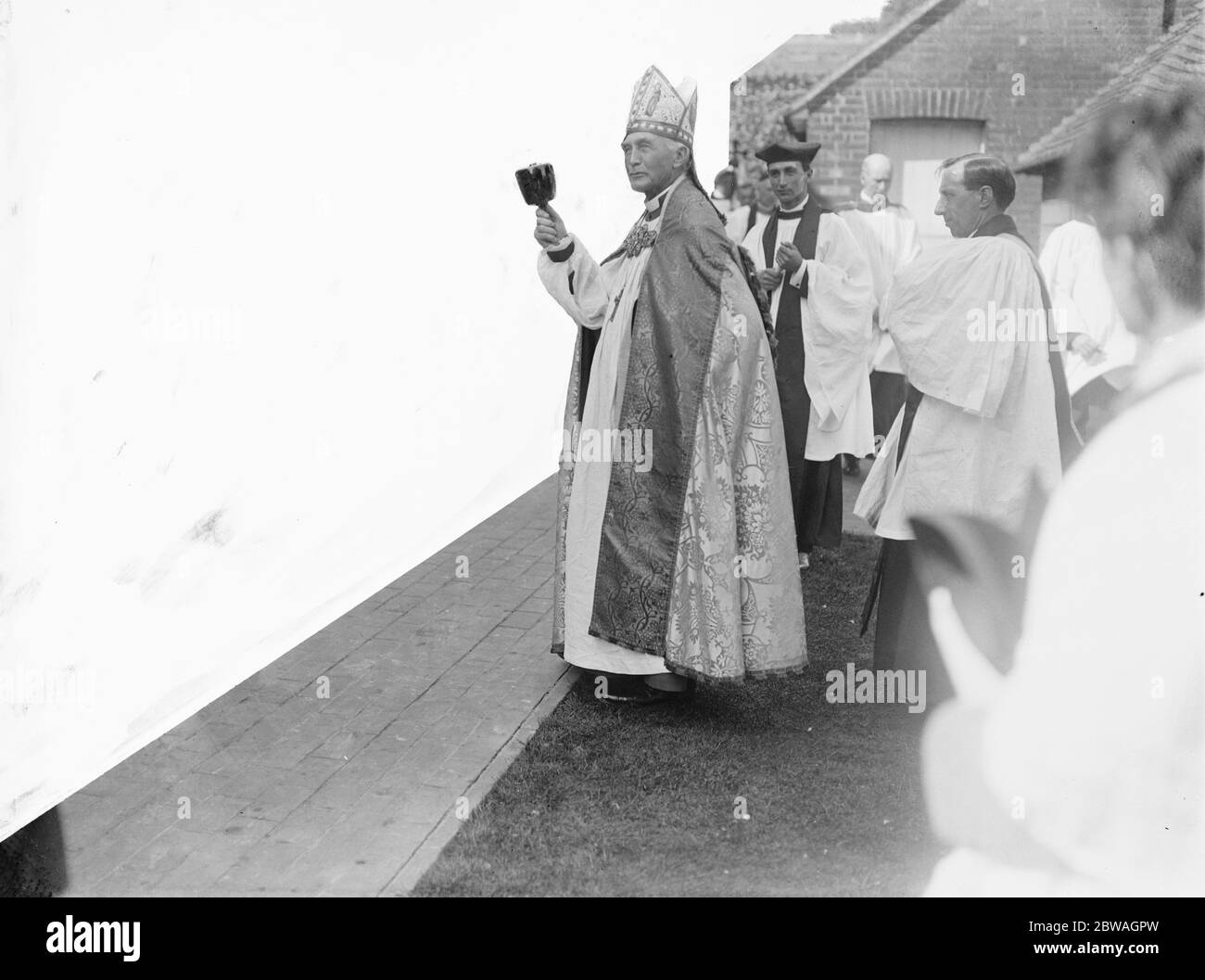 L'évêque de Londres pose la pierre de fondation de l'extension à la chapelle de l'école d'artisanat de Chailey Heritage . L'évêque soulignant son adresse aux enfants à l'aide du maillet avec lequel il a posé la pierre . 1922 Banque D'Images