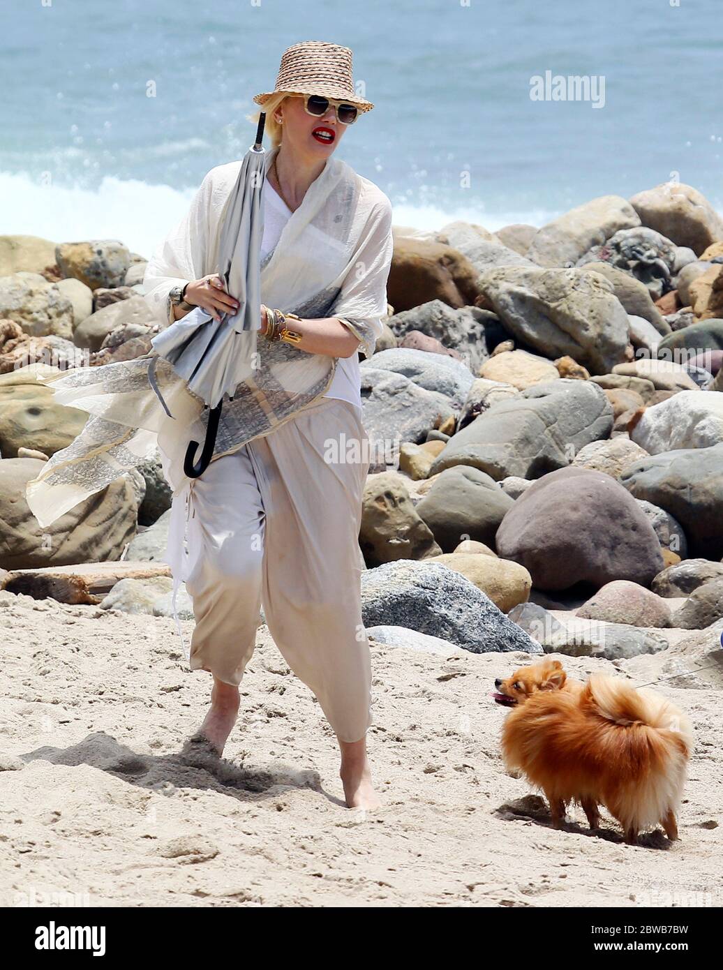 Gwen Stefani portant un chapeau, marchant sur la plage avec un chien et ses garçons Kingston et Zuma sur la plage, Malibu, juillet 2013 Banque D'Images
